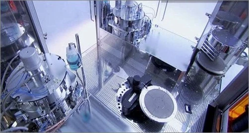 A wafer on a transfer arm between process chambers.